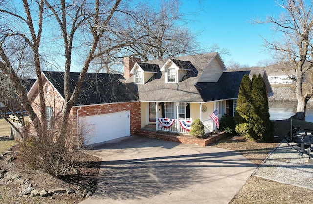 cape cod house with a garage and covered porch