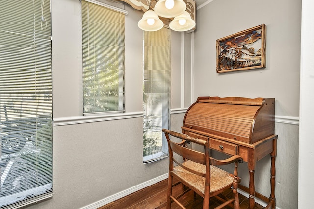 sitting room featuring wood-type flooring and ornamental molding