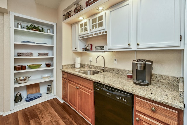 kitchen featuring sink, dishwasher, light stone counters, white cabinets, and dark hardwood / wood-style flooring