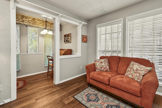 living room featuring an inviting chandelier and hardwood / wood-style floors