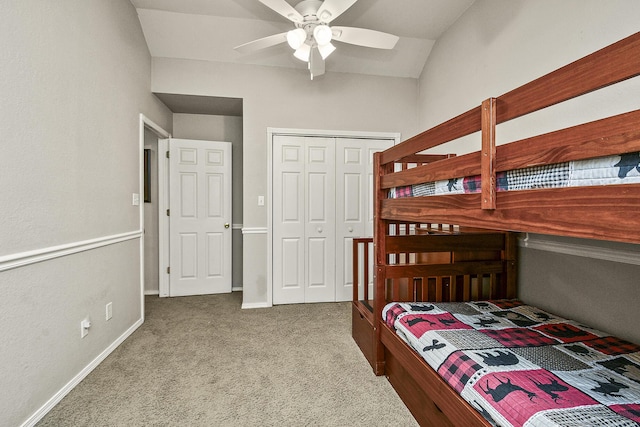 bedroom featuring lofted ceiling, light colored carpet, ceiling fan, and a closet