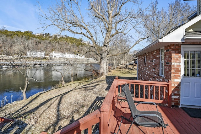 wooden deck featuring a water view