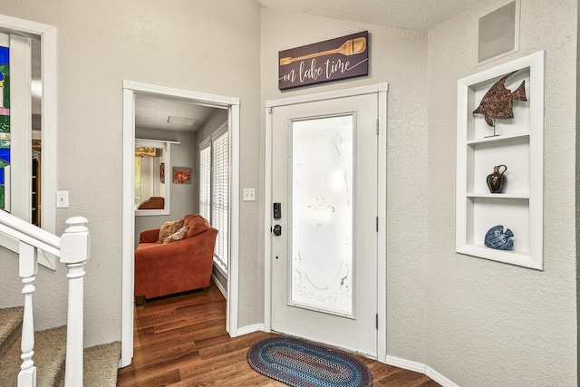 foyer entrance featuring dark hardwood / wood-style floors