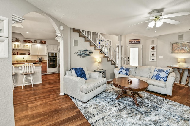 living room featuring dark hardwood / wood-style floors and ceiling fan