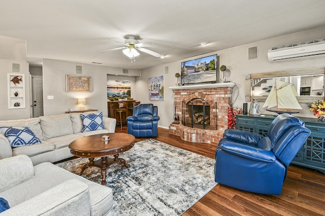 living room featuring dark hardwood / wood-style flooring, a brick fireplace, an AC wall unit, and ceiling fan