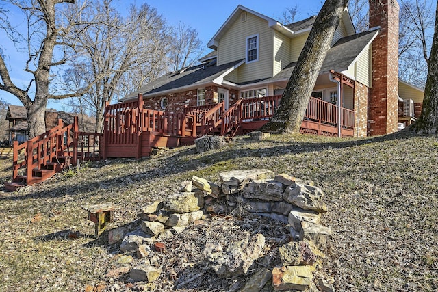 back of property featuring a wooden deck