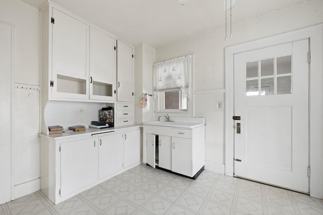 kitchen featuring white cabinetry and sink