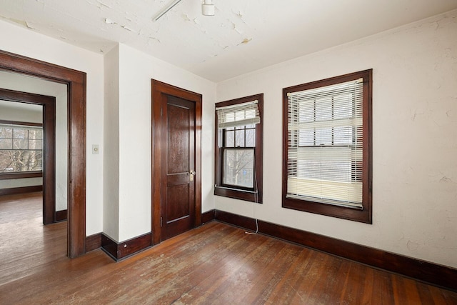 spare room with dark hardwood / wood-style floors