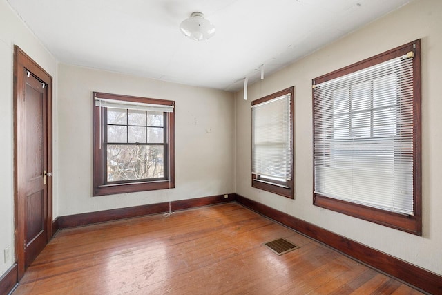 spare room with wood-type flooring