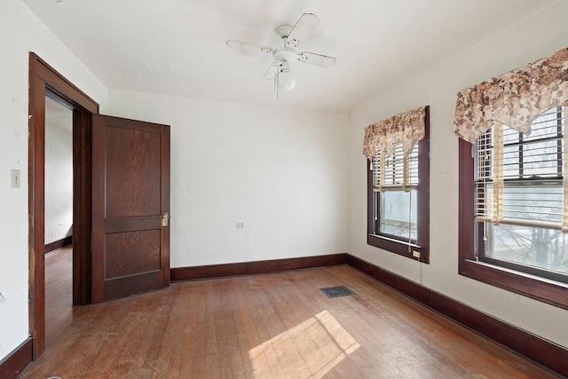 unfurnished room with hardwood / wood-style flooring and ceiling fan