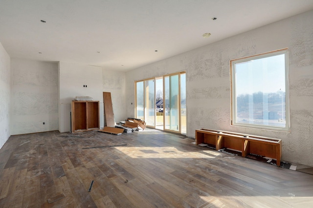 unfurnished living room with wood-type flooring