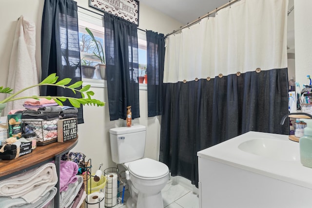 bathroom featuring vanity, toilet, and tile patterned flooring