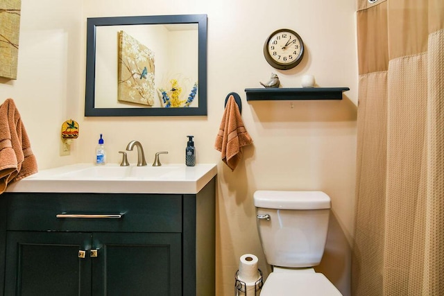 bathroom featuring vanity and toilet