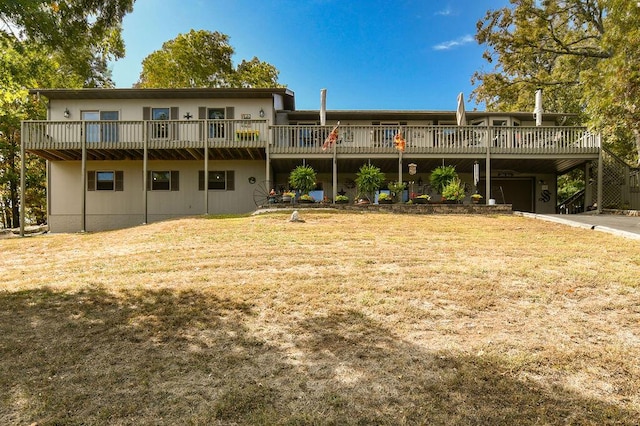 back of property featuring a deck and a lawn