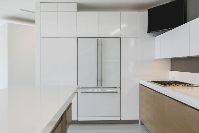 kitchen with stainless steel gas stovetop and white cabinets