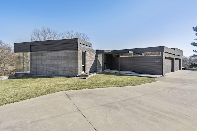 contemporary home with a garage, a front lawn, and a carport