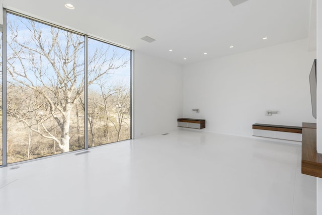 spare room with floor to ceiling windows and plenty of natural light