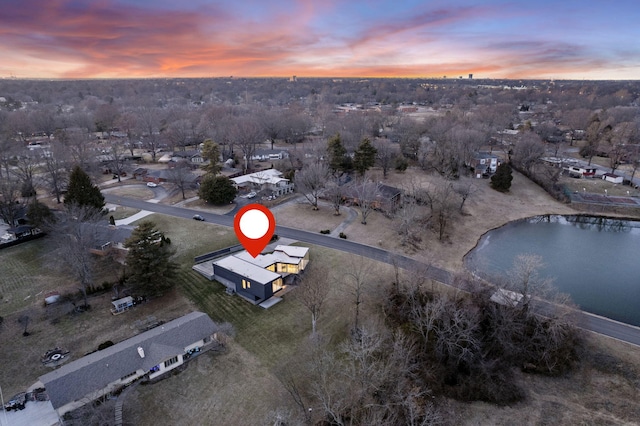 aerial view at dusk with a water view