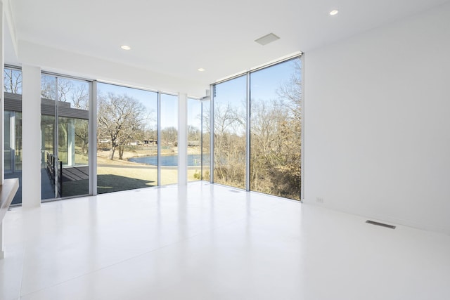 unfurnished room with a wealth of natural light and expansive windows