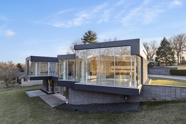 exterior space with a yard and a sunroom