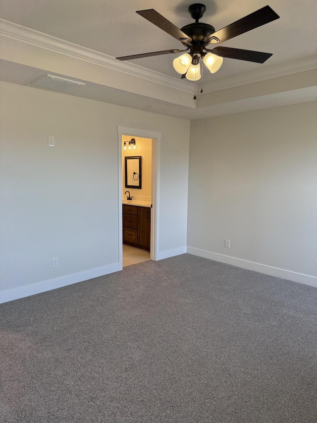 carpeted spare room featuring ornamental molding, sink, and ceiling fan