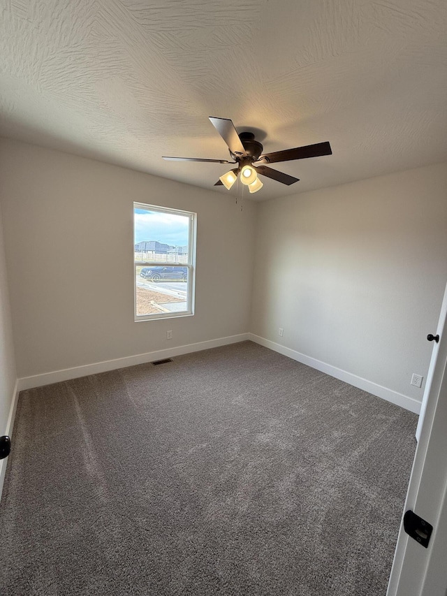 unfurnished room with a textured ceiling, ceiling fan, and carpet flooring