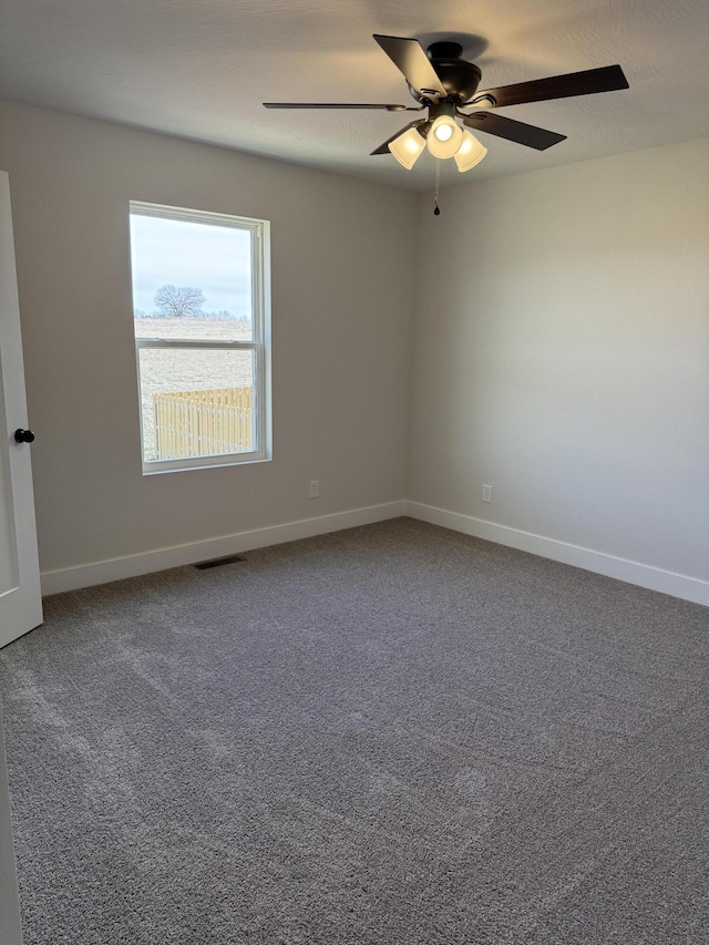 unfurnished room featuring ceiling fan, carpet, and a textured ceiling