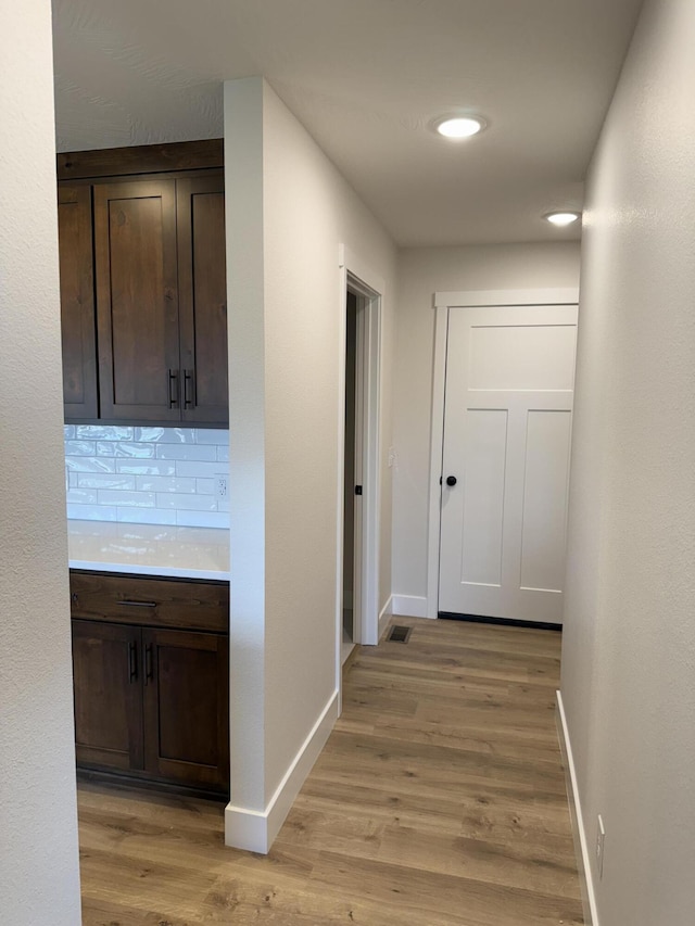 hall with light hardwood / wood-style floors