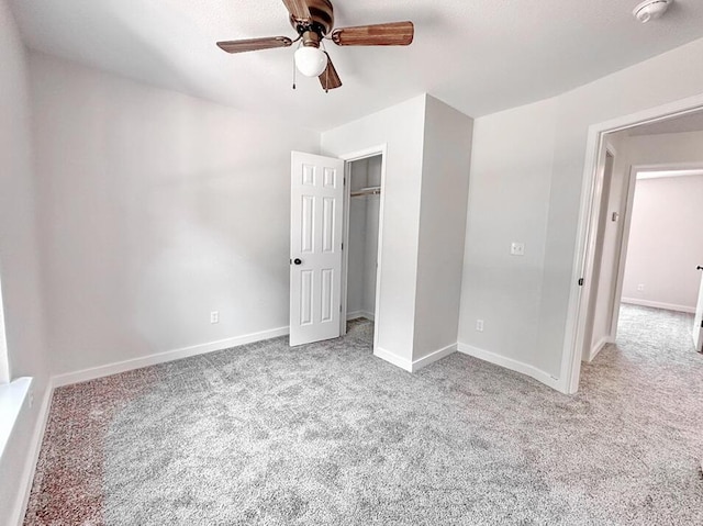 unfurnished bedroom with ceiling fan, light colored carpet, and a closet