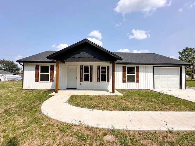 ranch-style home with a garage and a front lawn