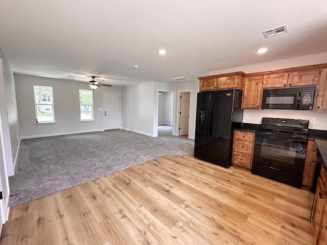 kitchen with ceiling fan, light wood-type flooring, and black appliances