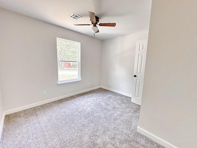 carpeted spare room with ceiling fan