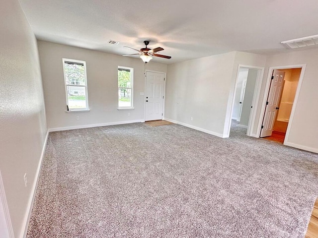 carpeted empty room featuring ceiling fan