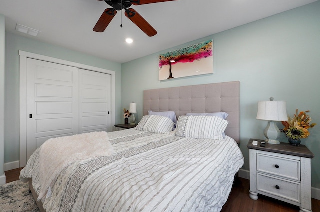 bedroom with ceiling fan, dark hardwood / wood-style flooring, and a closet