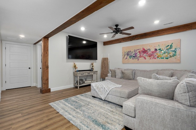 living room featuring wood-type flooring and ceiling fan