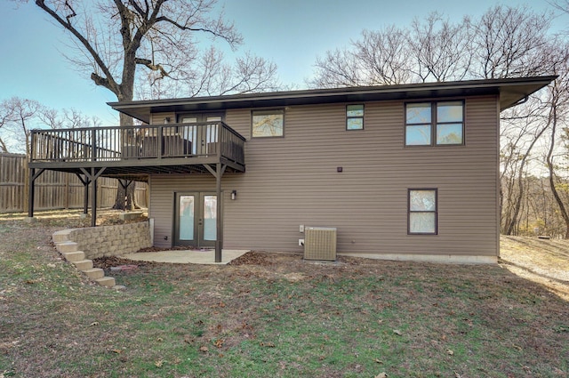 rear view of house with cooling unit, a deck, a patio, and french doors