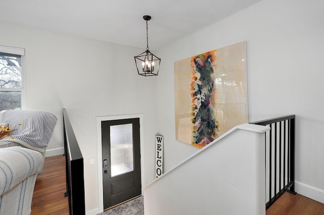 entrance foyer with a notable chandelier and dark hardwood / wood-style floors