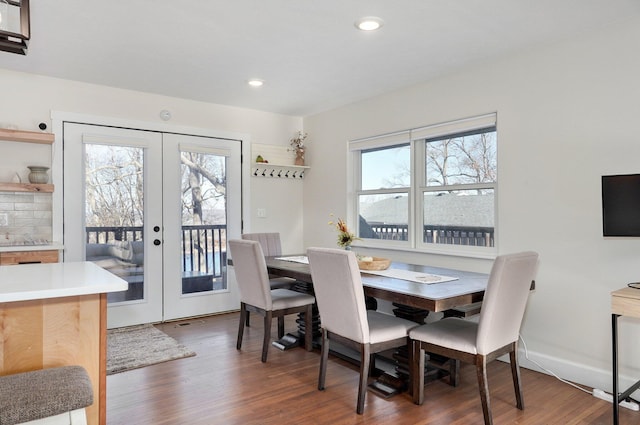 dining space with dark hardwood / wood-style flooring and french doors