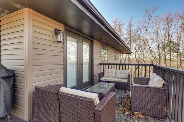 wooden terrace with french doors and outdoor lounge area