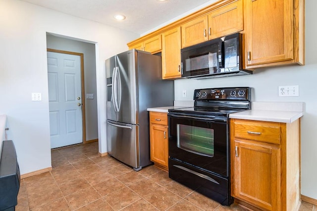 kitchen featuring tile patterned floors and black appliances