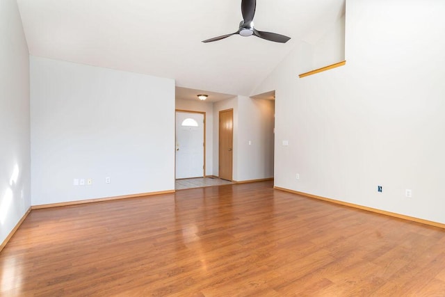 spare room with light hardwood / wood-style flooring, high vaulted ceiling, and ceiling fan