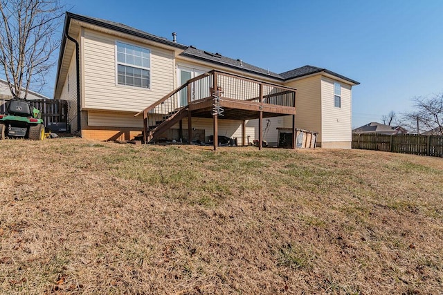 rear view of property with a yard and a deck