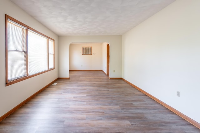 unfurnished room with light hardwood / wood-style floors