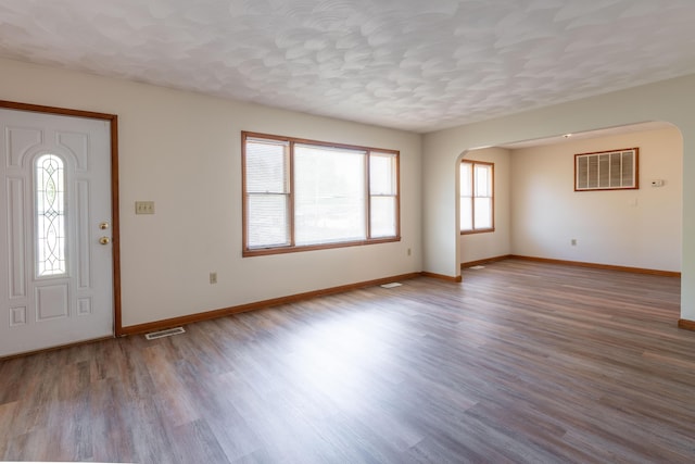 foyer featuring light hardwood / wood-style floors and a textured ceiling