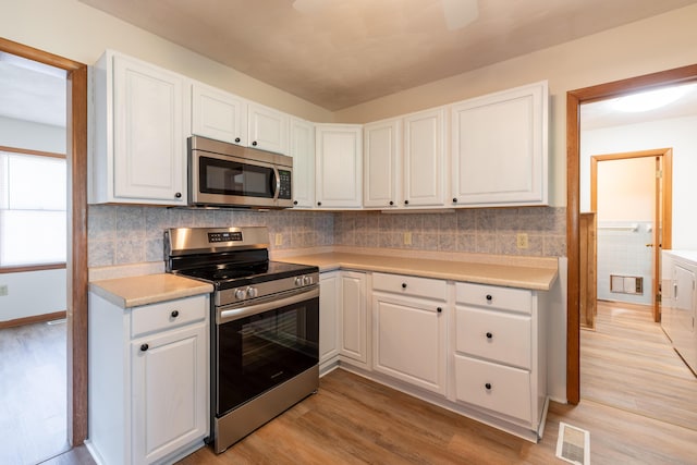 kitchen featuring white cabinetry, appliances with stainless steel finishes, and light hardwood / wood-style floors