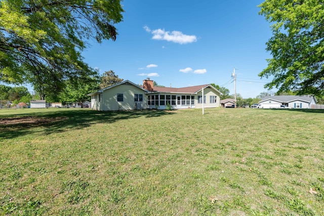 rear view of house with a lawn