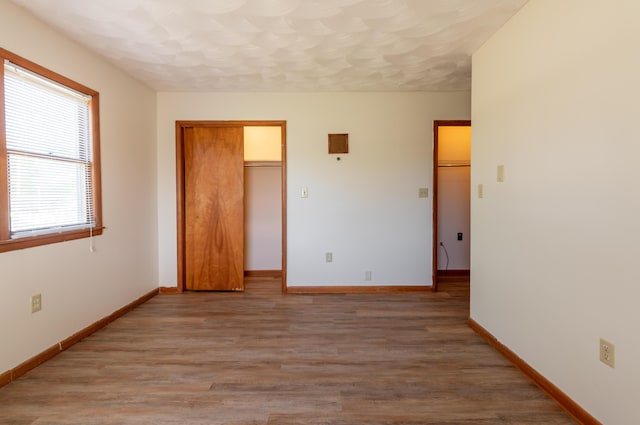 unfurnished bedroom with hardwood / wood-style flooring and a closet