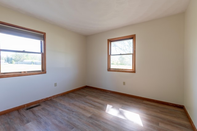 empty room with light hardwood / wood-style flooring