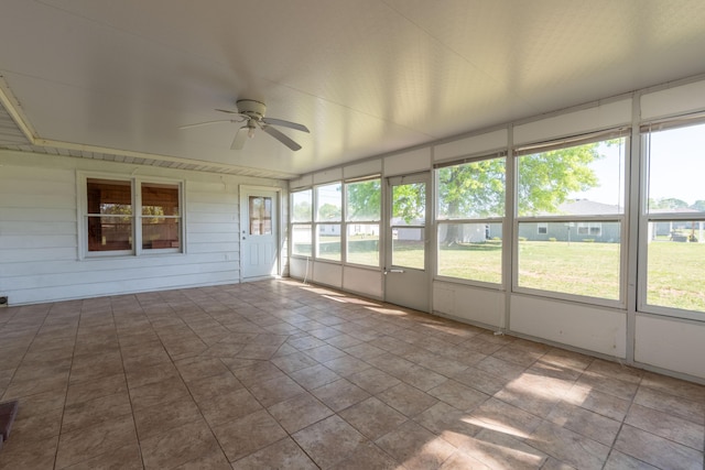 unfurnished sunroom with ceiling fan