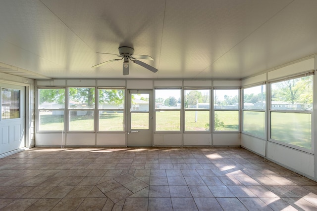 unfurnished sunroom with ceiling fan and a wealth of natural light